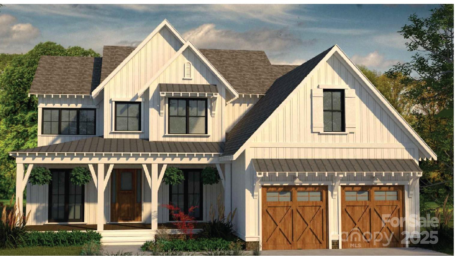 White two-story house with a covered porch, multiple gables, and a two-car garage with wooden doors.