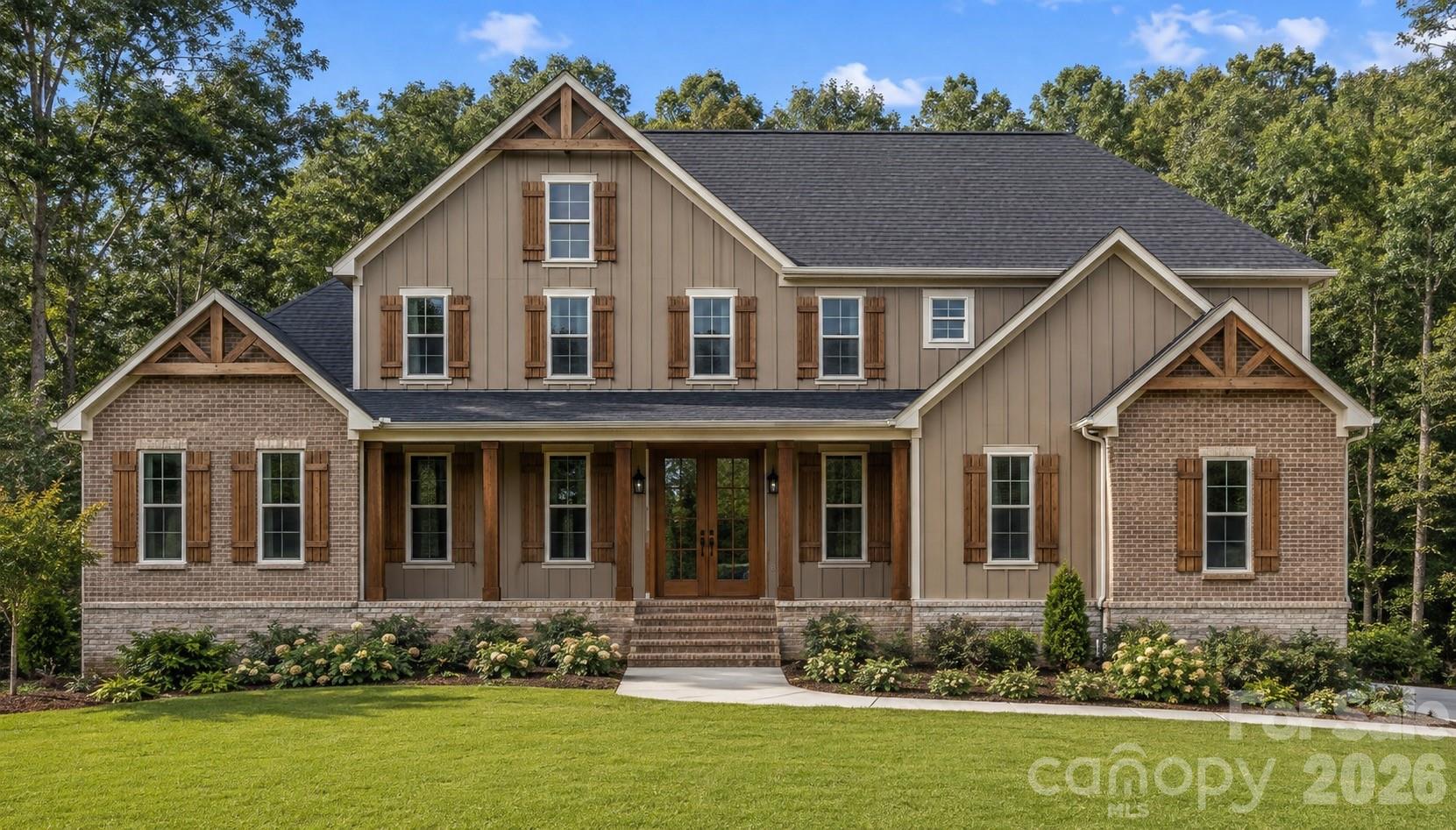 Two-story home with brick wings, timber gables, and a landscaped front lawn.